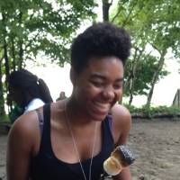 woman smiling with a roasted marshmallo